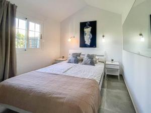 a bedroom with a large bed and a window at cozy & modern bungalow w/private garden bbq+wifi in Maspalomas +45 photos