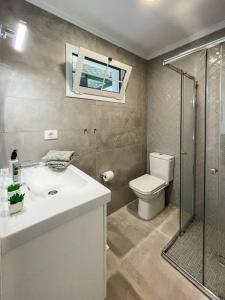 a bathroom with a toilet and a sink and a shower at cozy & modern bungalow w/private garden bbq+wifi in Maspalomas