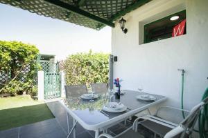 a table and chairs sitting on a patio at cozy & modern bungalow w/private garden bbq+wifi in Maspalomas