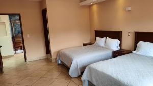 Postel nebo postele na pokoji v ubytování Suites Del Risco