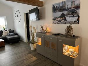 a living room with a cabinet and a fireplace at FEWO Hoppegarten in Hoppegarten