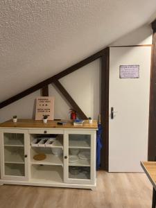een kamer met een witte kast en een deur bij Authentic Loft - 10 min to the city center in Schiltigheim