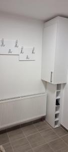 a room with a white wall with drawings on the wall at Snowman Studio Apartment Jahorina in Jahorina