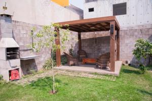 a gazebo with chairs and a table in a yard at Yes Vancouver Flats in Corumbá