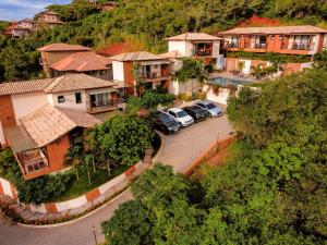 an aerial view of a village with cars parked in a parking lot at Pousada Villa Canaã in Búzios