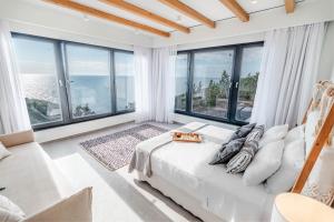 A bed or beds in a room at Luxury Villa Terra Promessa - Paxos