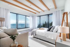 A bed or beds in a room at Luxury Villa Terra Promessa - Paxos