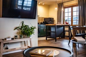 two views of a kitchen and a living room at Willa Leluja in Zakopane