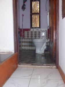 a bathroom with a toilet and a window at Steven and Dayness homestay in Lushoto