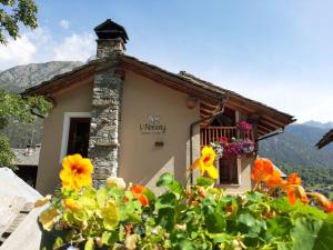 a small house with flowers in front of it at L'Abreny in Brusson