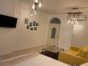 ein Zimmer mit einem Bett, einer Couch und einem Tisch in der Unterkunft White view in Mas'ada