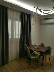 a dining room with a table and chairs at Apartman Hill in Mirijevo