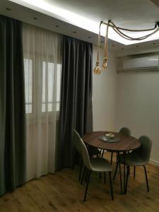 a dining room with a table and chairs at Apartman Hill in Mirijevo +8 photos