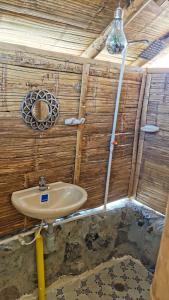 a bathroom with a sink in a wooden wall at Pachingo Tatacoa Desert in Pachingo