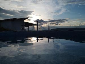 a pool of water in front of a building at Villa Namaste - Cabaña Excélsior in Curití
