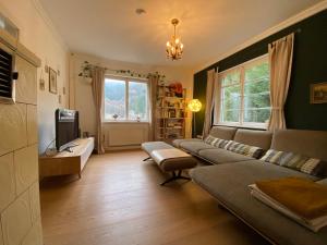 a living room with a couch and a tv at Ferienhaus Waldglück in Calw