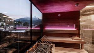 a balcony with a bench and a view of a mountain at die berge lifestyle-hotel Sölden in Sölden