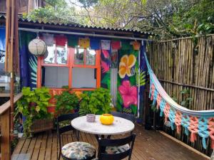 a patio with a table and chairs on a deck at Hostel do Morro in Florianópolis