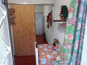 a room with a table and a door and a room with a curtain at Casa amora olinda in Olinda +6 photos