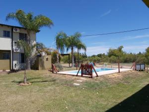a swimming pool with a slide in a yard at Complejo Antares in San José