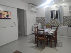 a kitchen and dining room with a table and chairs at Trentino 66 - Hospedagem em Ijuí, casa agradável com estacionamento in Ijuí