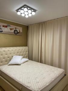 a bedroom with a bed with a car picture on the wall at Apartament Nicolle in Poiana Brasov