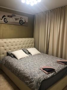 a bedroom with a bed with a car on the wall at Apartament Nicolle in Poiana Brasov