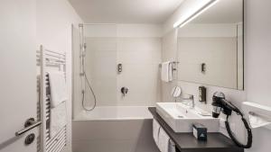 a bathroom with a sink, toilet, and shower at die berge lifestyle-hotel sölden in Sölden