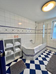 a bathroom with a tub and a glass shower at Haus Stille Nacht Wagrain in Wagrain