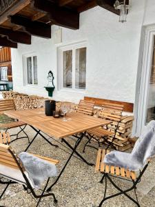a patio with a wooden table and chairs at Haus Stille Nacht Wagrain in Wagrain