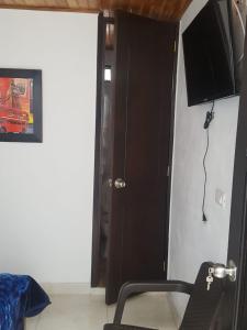 a room with a black door and a black chair at Hotel San Agustín in San Agustín