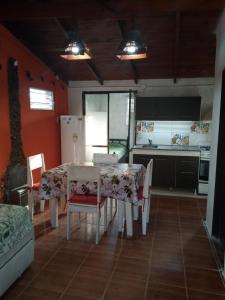 a kitchen with a table and chairs and a refrigerator at Casa de alquiler 2 in Tanti