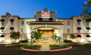 a rendering of the front of a hotel at Hawthorn Extended Stay by Wyndham College Station in College Station