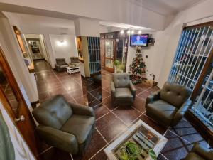 a living room with two chairs and a christmas tree at Hotel Mar in Mar del Plata