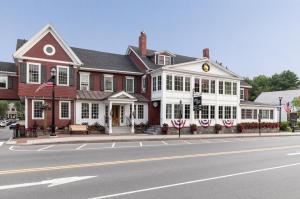 a large red and white house on the corner of a street at Green Mountain Inn in Stowe