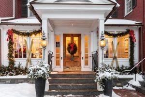 a house with christmas wreaths on the front door at Green Mountain Inn in Stowe