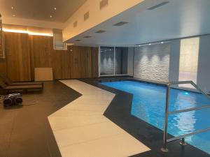 a large swimming pool in a hotel room at Villa Del Rosensuite in Pinzolo