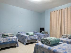 מיטה או מיטות בחדר ב-Pousada Emanuell