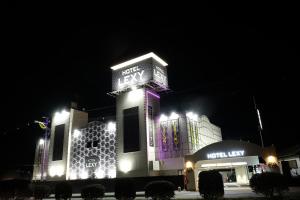 a large building with lights on it at night at Hotel LEXY旧Tsubakikan Adult Only in Nara