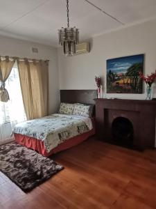 a bedroom with a bed and a fireplace at QTEN CASINO in Pietermaritzburg +41 photos