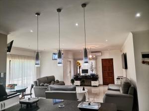 a living room with two couches and a table at QTEN CASINO in Pietermaritzburg