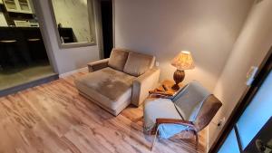 an overhead view of a living room with two chairs and a lamp at NEO CASA in Gramado