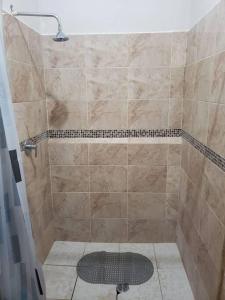 a bathroom with a shower with a tiled shower at Casa de campo by the river in Estelí