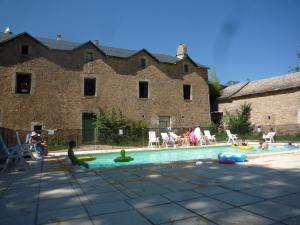 a group of people playing in a swimming pool at Domaine De Pradines in Lanuéjols