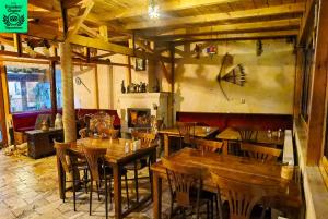 a restaurant with wooden tables and chairs in a room at Larissa Cave Hotel in Nevşehir