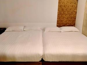 Postel nebo postele na pokoji v ubytování BTC Hua Hin Home managed by BTC Boutique Resort