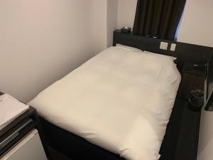 Voodi või voodid majutusasutuse Nagoyaeki Access Hotel toas