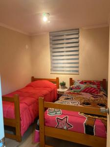 two beds sitting next to each other in a bedroom at Departamento para 6 personas in Villarrica +13 photos
