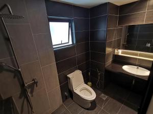 a bathroom with a toilet and a sink at Pax6+2 Melaka Famous Homestay Klebang Homefeel in Melaka +32 photos