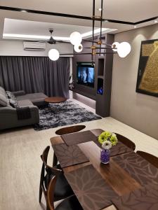 a living room with a dining table and a couch at Pax6+2 Melaka Famous Homestay Klebang Homefeel in Melaka